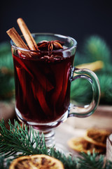 Christmas hot mulled wine in a glass with spices and citrus fruit. Mulled wine with cinnamon, anise and orange