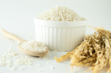 Close up rice in white bowl with wheat on isolated white background