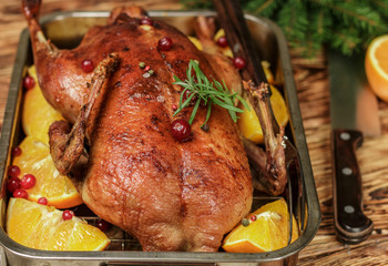 Festive duck baked with oranges, cranberries, rosemary and spices close-up. New year. Christmas. Selective focus