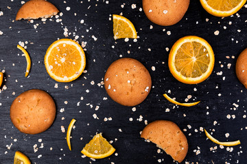 Fototapeta na wymiar Oatmeal cookies and orange citrus fruit background. Flat lay