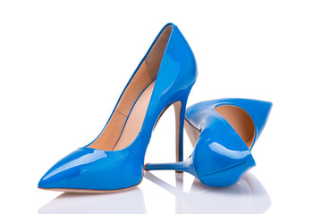 A pair of blue lacquer shoes on a white background