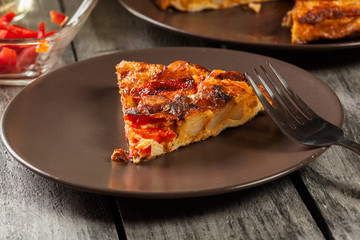 Tortilla de patatas. Spanish omelette with sausage chorizo, potatoes, paprika and egg, accompanied by olive oil