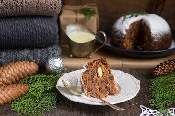 English Christmas pie with vanilla sauce in festive decoration. Rustic style.