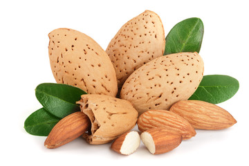 Group of almond nuts with leaves isolated on white background