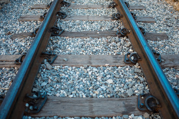 Naklejka premium railway tracks have railway pillow and stone are background. this image for business, transport, train, texture, abstract, industrial, carriage concept