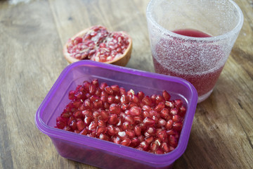 pomegranate seeds and juice in a glass