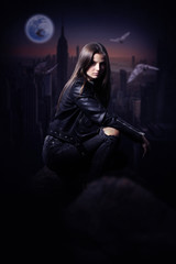 Beautiful Mysterious woman in black leather jacket overlooking the city during the night.Book cover. - obrazy, fototapety, plakaty