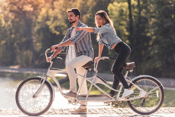 Couple with a tandem bicycle