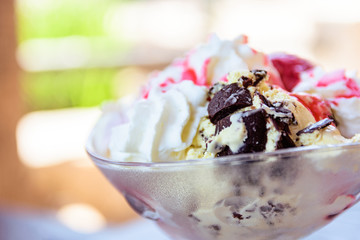 Vanilla Ice Cream Sundae In Bowl With Sauce And Dark Chocolate