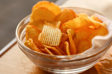 Potato Chips In Bowl On Wooden Table At Sunset