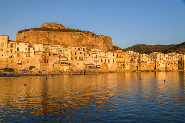 View of the old medieval town of Cefalù at sunset from the old harbour