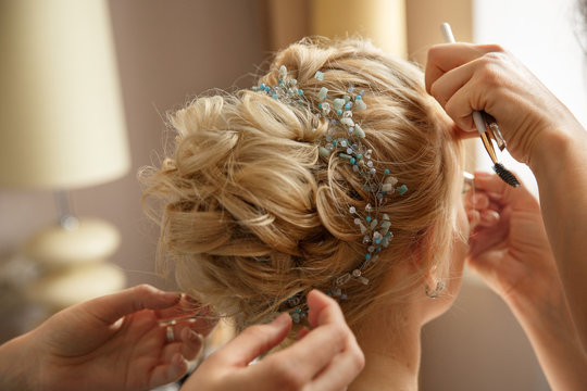 Wedding hairstyle and makeup. Makeup artist made makeup for beautiful bride at wedding day
