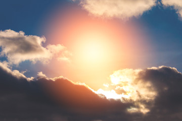 Dramatic view of a fluffy clouds against  a sunlight. Toned (background)