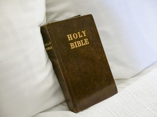 Fototapeta na wymiar Holy Bible book placed on hotel room bed