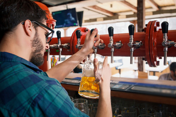 The bartender is working behind the bar