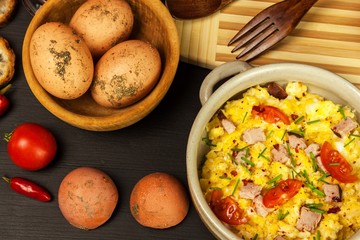 Scrambled eggs with herbs, simple, full protein breakfast with fresh herbs. Bio eggs from domestic breeding. Healthy food.