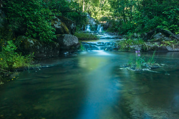 A beautiful river with small watefalls and bridge