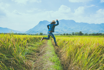 Asian man travel relax in the holiday. Jump natural touch mountain field. Jump stand glad middle field rice. Thailand