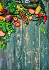 Harvest fresh vegetables on old wooden board top view rustic