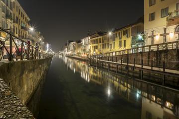 Fototapeta na wymiar Milan, Italy: the Naviglio Grande canal waterway at evening. This district is famous for its restaurants, cafes, pubs and nightlife.