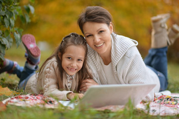 woman and  girl  using  laptop
