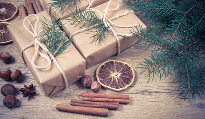 Christmas gifts in rustic boxes on wooden background.