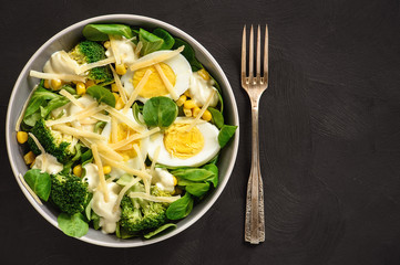 Healthy vegetarian salad with eggs, broccoli, corn and cheese