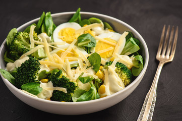 Healthy vegetarian salad with eggs, broccoli, corn and cheese