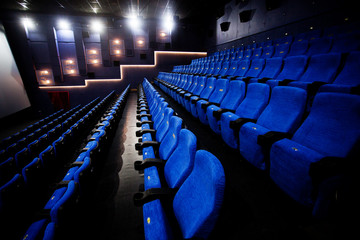 Naklejka premium Empty comfortable red seats with numbers in cinema 