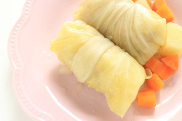 Homemade stuffed cabbage on dish with carrot