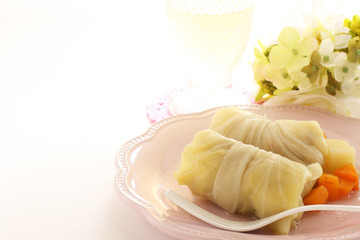 Homemade stuffed cabbage on dish with carrot