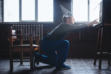 Strange man in tinfoil cap reaches out to TV, UFO