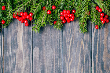 Fototapeta na wymiar Christmas composition of fir branches and berries of viburnum on a wooden background 