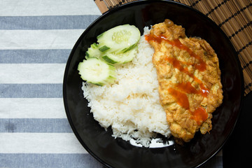 Omelet with rice on a table.