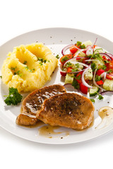 Fried pork chop, puree and vegetables on white background