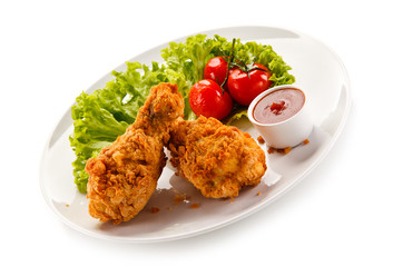 Fried chicken drumsticks on white background