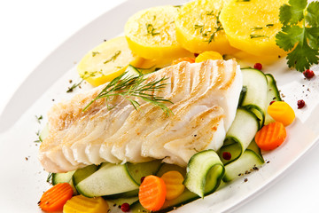 Fried fish with potatoes on white background
