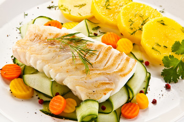 Fried fish with potatoes on white background