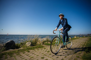 Fototapeta na wymiar Businessman cycling at seaside