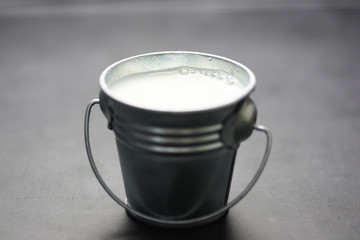 Milk in aluminum can isolated on dark background