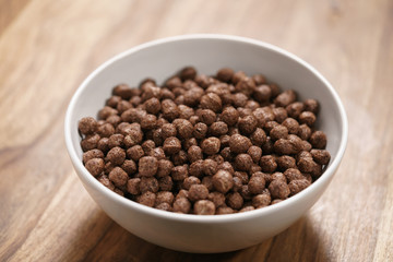chocolate cereal balls in white bowl for breakfast