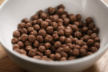 chocolate cereal balls in white bowl for breakfast