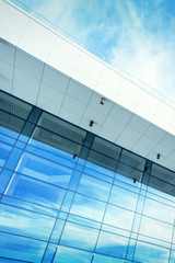 Fototapeta na wymiar Modern building with a blue glass facade against the sky