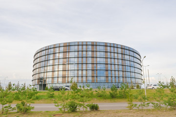 Round modern building with a blue glass facade