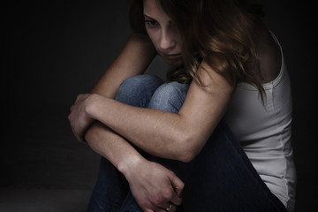 Frustrated woman in depression alone with  problems sitting on a dirty floor. (difficulties, psychology, body language, gestures, loneliness concept)