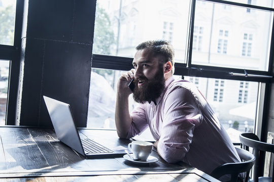 Young male hipsters freelancer working with laptop computer (freedom, distance work, remote jobs, success concept)