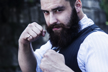 Angry bearded businessman hipster standing in boxer position and ready to fight