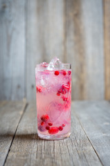 Tasty christmas cocktail with cranberry and foxberry. Shallow depth of field. Selective focus.