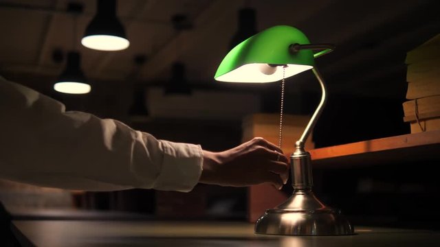 Business Woman Turned Off Green Table Lamp in Office. 4K.
