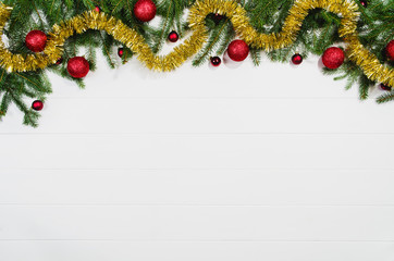 Fototapeta na wymiar Christmas background frame top view on white wooden plank table background with copy space around products. Decorations isolated on white. Horizontal composition.